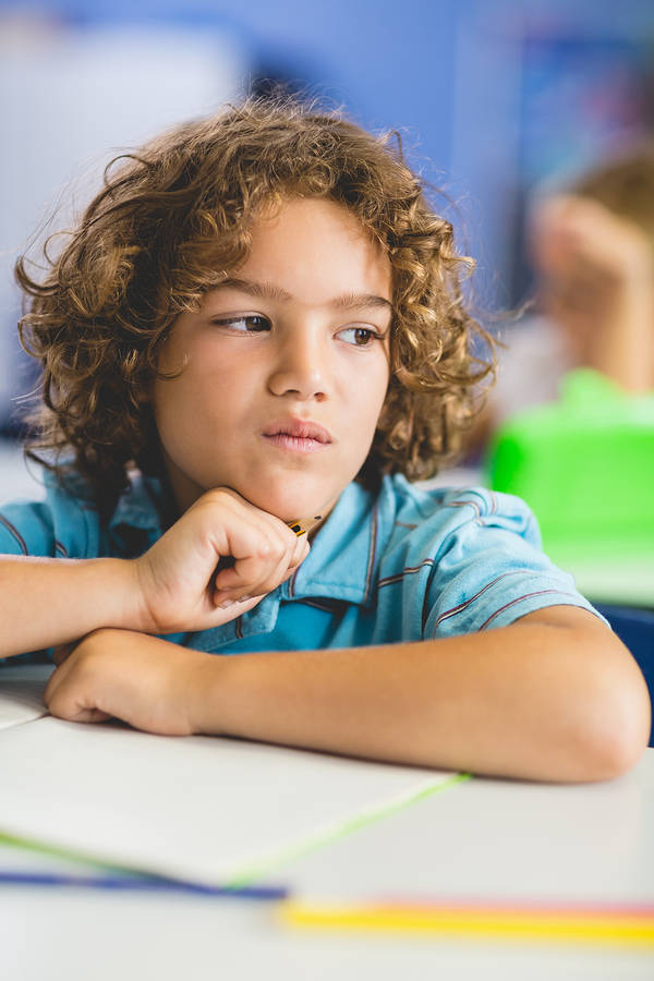 A student who is learning English studying in the classroom. English Language Learner.